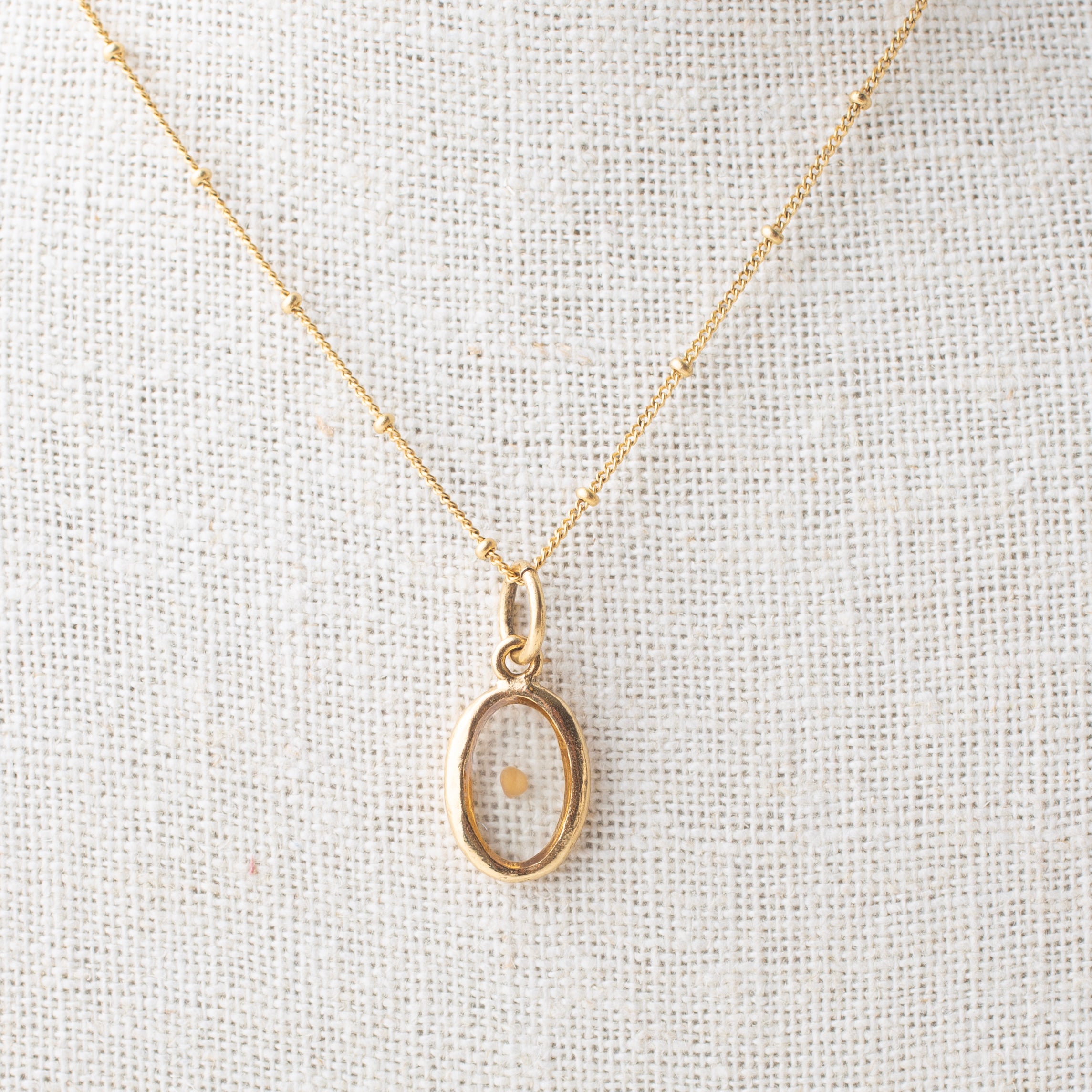 Mustard Seed Oval Charm